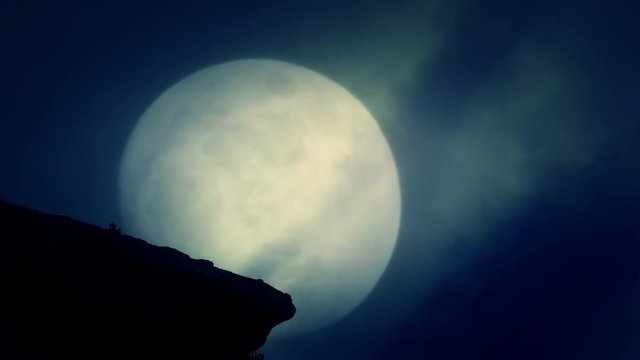 A Cliff at Night on a Rising Full Moon Background on a Spooky Night
