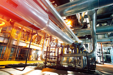 Equipment, cables and piping as found inside of a modern industr