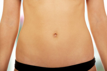 Fit and slim young woman belly. - obrazy, fototapety, plakaty