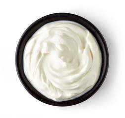 Bowl of cream isolated on white background, from above