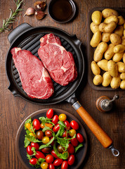 Raw beef steak on grill pan from above