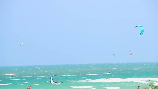 Many glide surfing, kite board surfing sport playing in the ocean