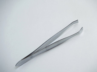 Tweezers on white background