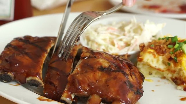 Barbecue baby pork ribs spare with with juicy sauce coleslaw and mashed potatoes