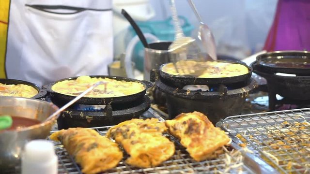 Fried seafood and mussel roll egg pancakes in hot plate, Thai street food