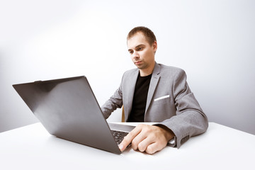 Handsome businessman working with laptop in office