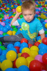Fototapeta na wymiar kid playing in pool of balls