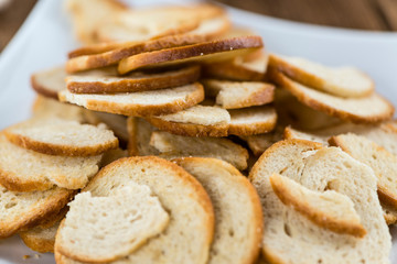 Bread chips on wooden background