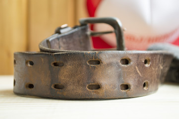 rough leather belt on jeans background