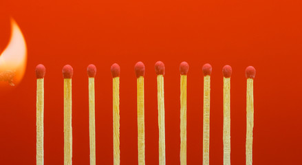 Burning matchsticks setting fire to its neighbors