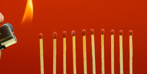 Burning matchsticks setting fire to its neighbors
