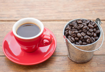 Red cup of espresso on wooden table