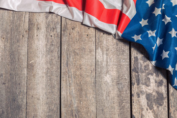 An American Flag Lying on an aged, weathered rustic wooden background