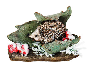 Christmas composition of hedgehog, mountain ash, stone and leaf isolated on white background.