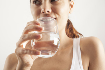 Young woman drinking  glass of water