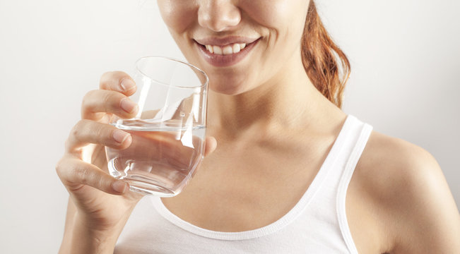 Young woman drinking  glass of water
