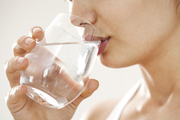 Young woman drinking  glass of water