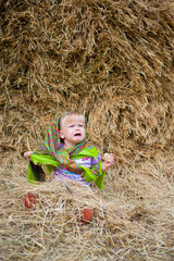 Close up image of beautiful little girl in russian village traditional kerchief with round cracknel  over autumn weather