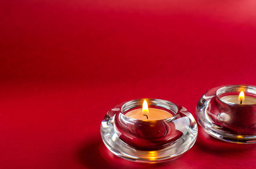 Candles on a red background. Place for text.