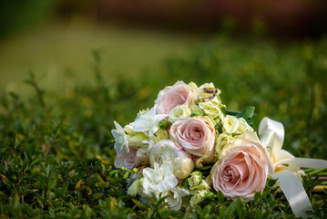 wedding bouquet with rings on grass.