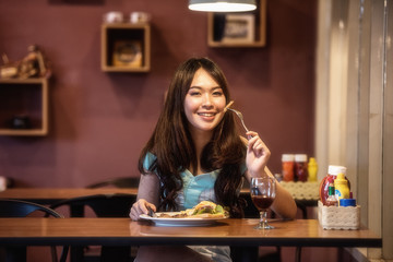 Woman eating steak in a restaurant
