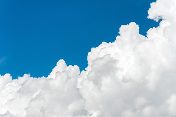 Naklejka na ściany i meble Blue dramatic sky background with fleecy curly soft white clouds