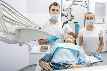 Dentist, assistant and patient in clinic