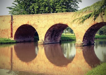 Fototapeta na wymiar ancient arched bridge made of red bricks