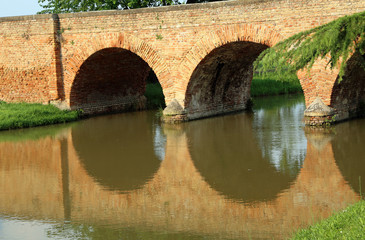 ancient arched bridge made of red bricks