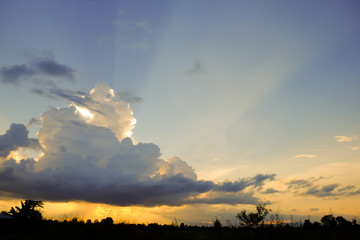Dramatic sunset and sky Sunset with clouds, light rays on field at countryside background backdrop use