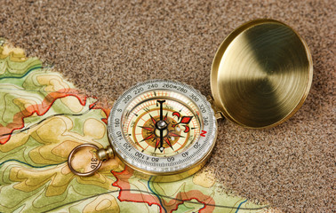 compass on the map with sand