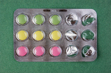 Pack of pills on a green background