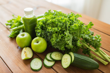 close up of bottle with green juice and vegetables