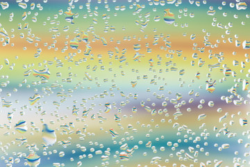 Colorful candies in the water drops.