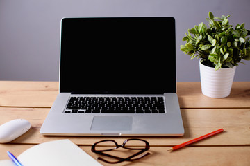 stack of papers on the desk with  computer