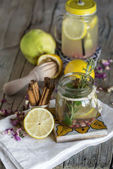 Lemonade with fresh lemon on wooden background