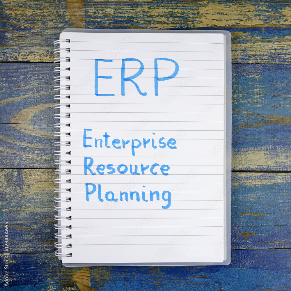Poster erp- enterprise resource planning written in notebook on wooden background