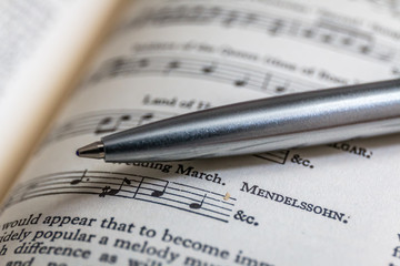 music notes and a pen