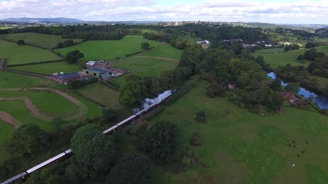 Aerial view of a steam train powering through the Severn Valley, UK.