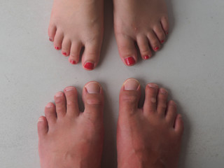 Fototapeta premium Twenty toes with partially painted nails