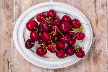 Fresh red Cherries on wooden table macro background