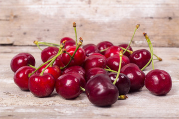 Fresh red Cherries on wooden table macro background