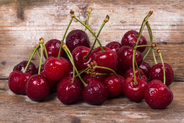 Fresh red Cherries on wooden table macro background