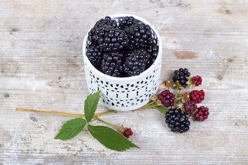 Blackberries on a wooden table and mint leaves