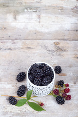 Fototapeta na wymiar Blackberries on a wooden table and mint leaves