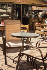 Fototapeta na wymiar table and chairs in a street cafe
