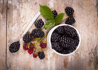 Blackberries on a wooden table and mint leaves