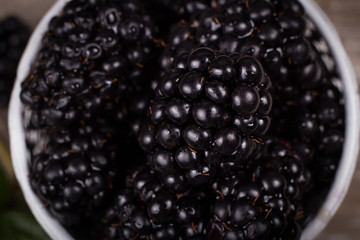 Blackberries on a wooden table and mint leaves