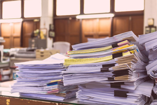 Pile Of Documents On Desk Stack Up High Waiting To Be Managed