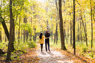 Fototapeta premium Lovely family walking in the autumn forest. Healthy lifestyle
